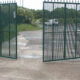 Large industrial steel gate painted in green colour which is operates automatically when the vehicles comes in or goes out.