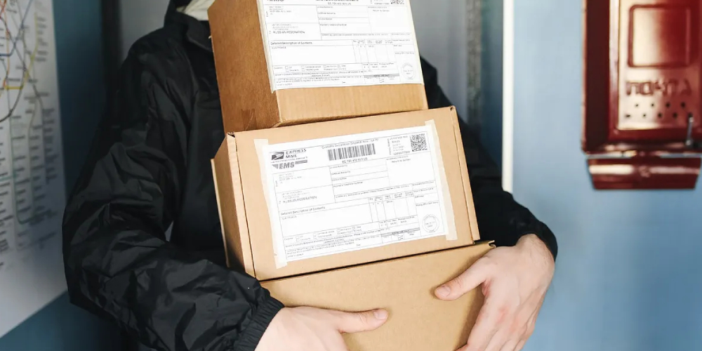 A delivery agent carrying a few boxes for delivery