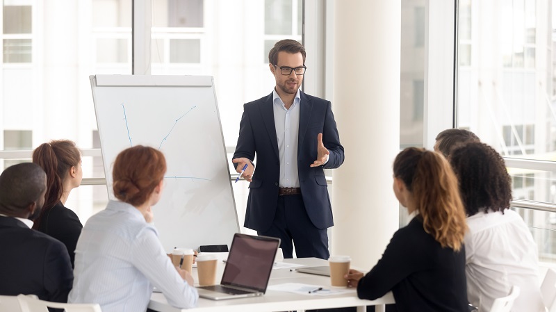 A team of business people having a discussion, and a businessman leading the meeting.